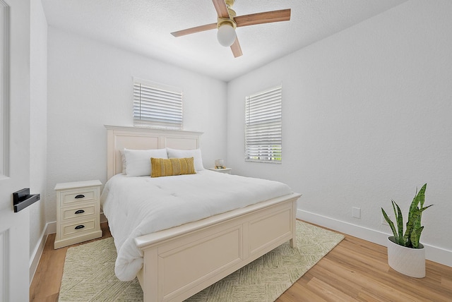 bedroom with light wood-type flooring and ceiling fan