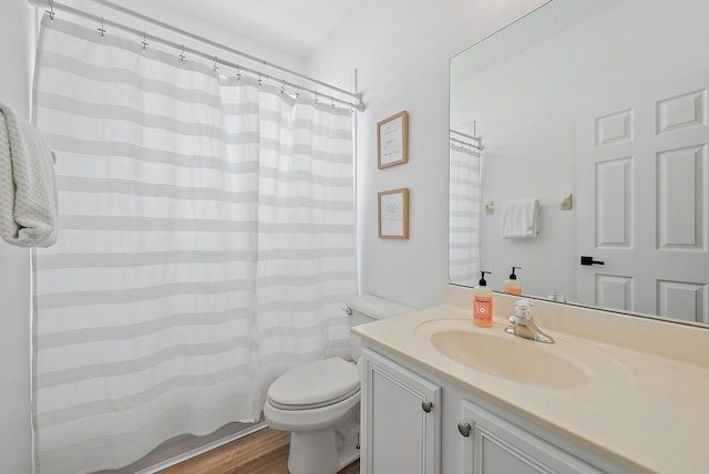 bathroom featuring hardwood / wood-style floors, toilet, and large vanity