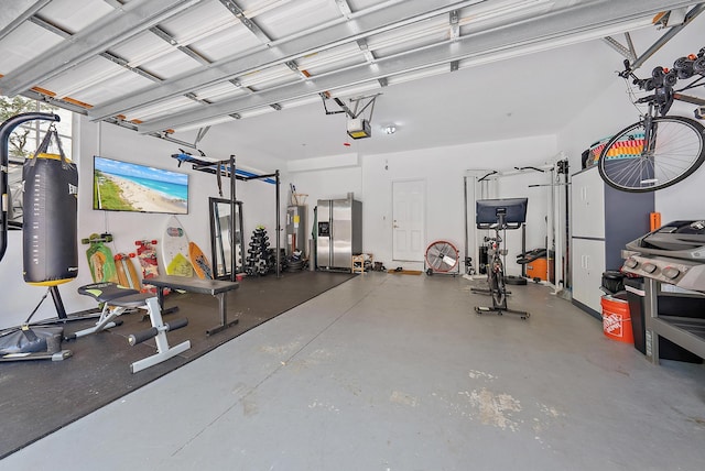 garage with stainless steel refrigerator with ice dispenser, a garage door opener, and gas water heater