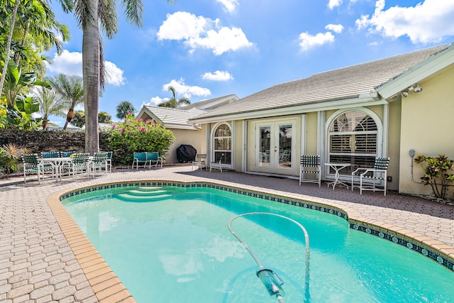 view of pool featuring a patio area and french doors