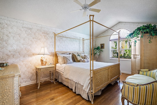 bedroom featuring hardwood / wood-style floors, ceiling fan, a textured ceiling, and lofted ceiling