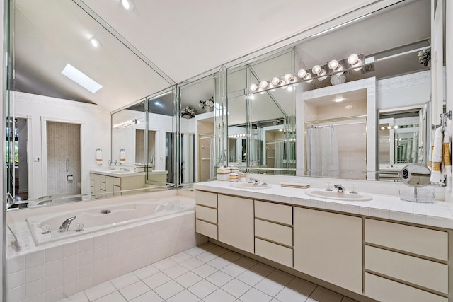 bathroom with tiled bath, tile floors, high vaulted ceiling, vanity, and a skylight