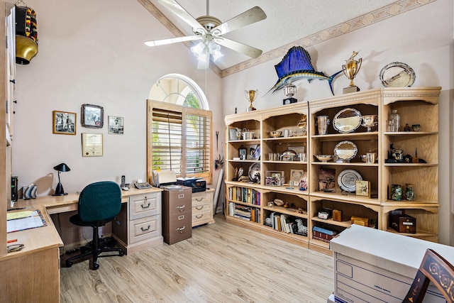 home office with high vaulted ceiling, a textured ceiling, ceiling fan, and light hardwood / wood-style flooring