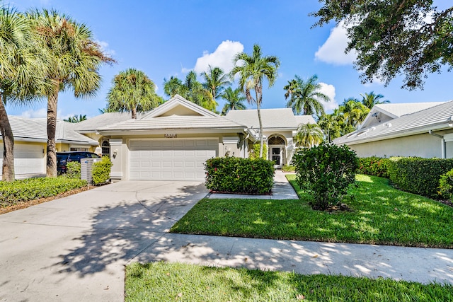 ranch-style home featuring a garage and a front yard