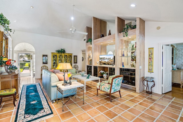 tiled living room with high vaulted ceiling and ceiling fan