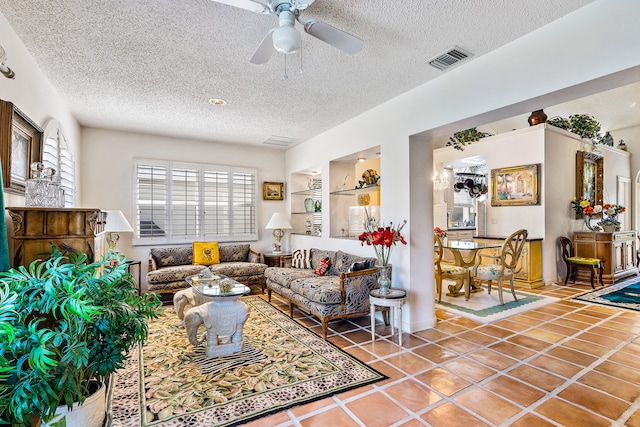 tiled living room featuring ceiling fan and a textured ceiling