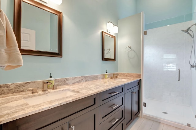 bathroom with vanity and a shower with door