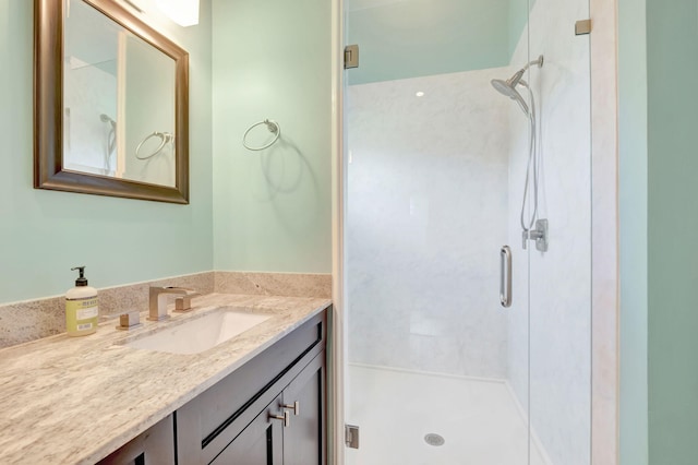 bathroom with vanity and a shower with door