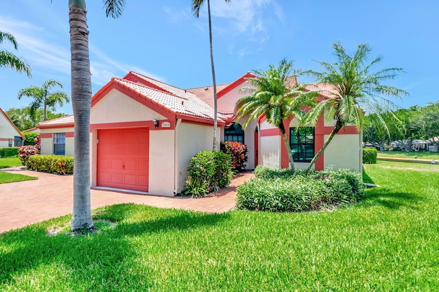 view of front of house featuring a garage and a front lawn