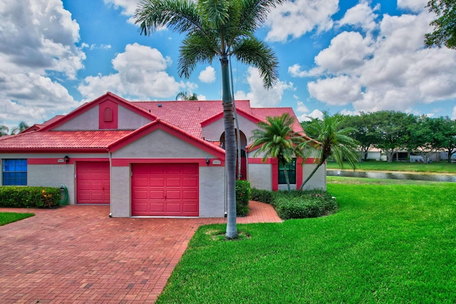 view of front of home with a front lawn and a garage