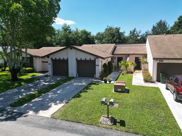 ranch-style home with a front yard and a garage