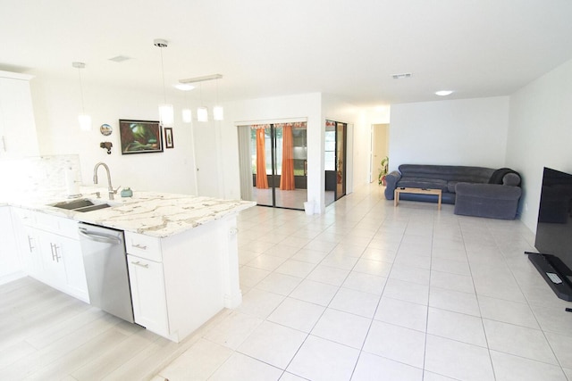 kitchen with dishwasher, white cabinets, sink, light stone countertops, and decorative light fixtures