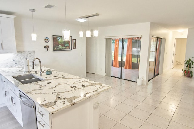 kitchen with white cabinetry, sink, dishwasher, and light stone countertops