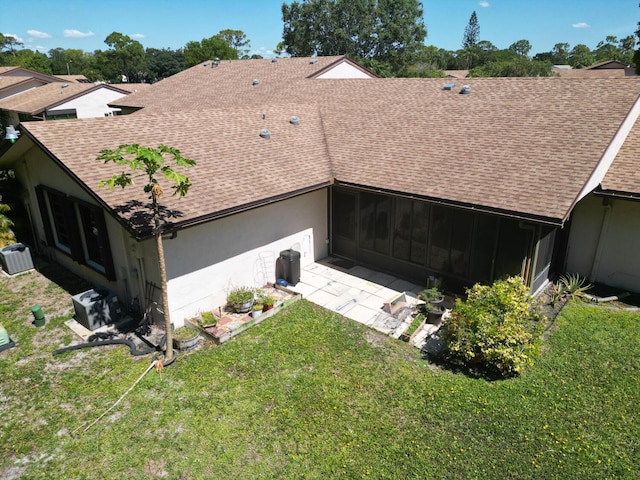 back of property with a yard and a patio area