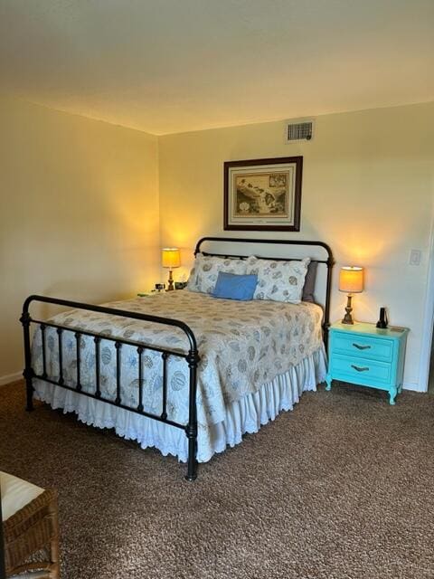 bedroom featuring dark colored carpet