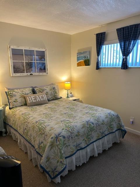 bedroom with carpet flooring and a textured ceiling