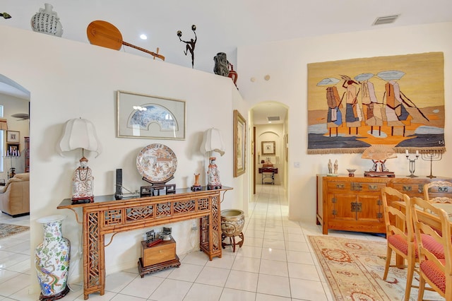 hall with tile patterned floors