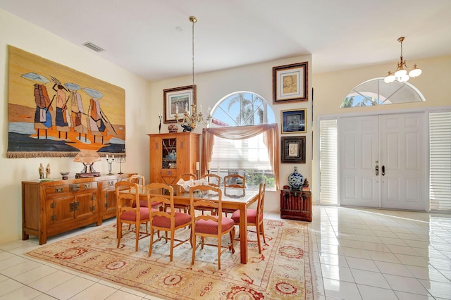 tiled dining area with a chandelier