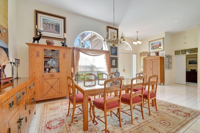 dining area with light tile patterned floors and a chandelier