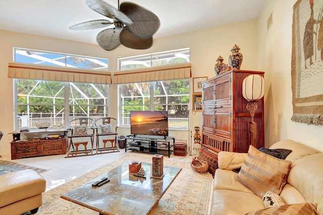 tiled living room with ceiling fan