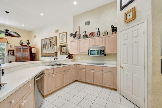 kitchen with appliances with stainless steel finishes, light brown cabinets, sink, and light tile patterned flooring