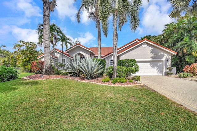 mediterranean / spanish home with a front yard and a garage