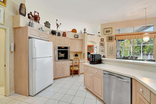 kitchen with stainless steel appliances, light brown cabinetry, light tile patterned floors, and decorative light fixtures