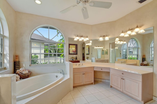 bathroom featuring vanity, tiled bath, plenty of natural light, and tile patterned flooring