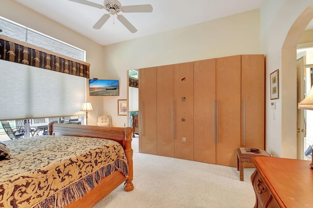 bedroom featuring multiple windows, light colored carpet, and ceiling fan