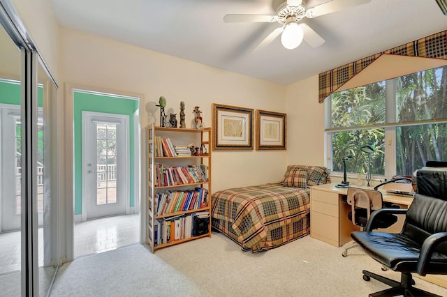 bedroom with ceiling fan, light carpet, and access to outside