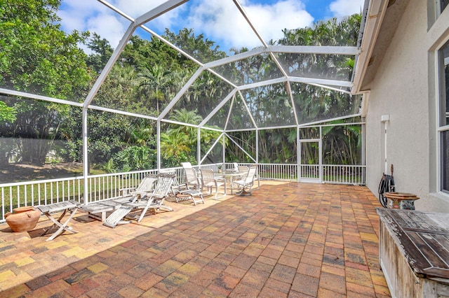 view of patio / terrace featuring glass enclosure