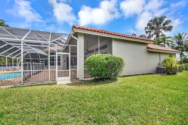 back of house with a patio, a lanai, a lawn, and cooling unit