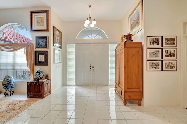 tiled foyer entrance with a notable chandelier