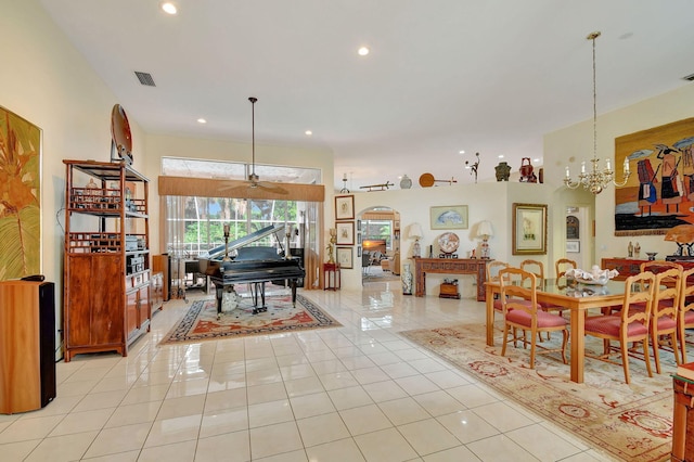 tiled dining room with an inviting chandelier