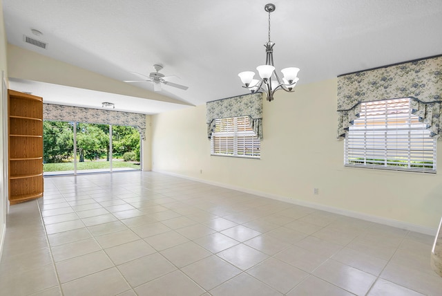 spare room with light tile patterned flooring, lofted ceiling, and ceiling fan with notable chandelier