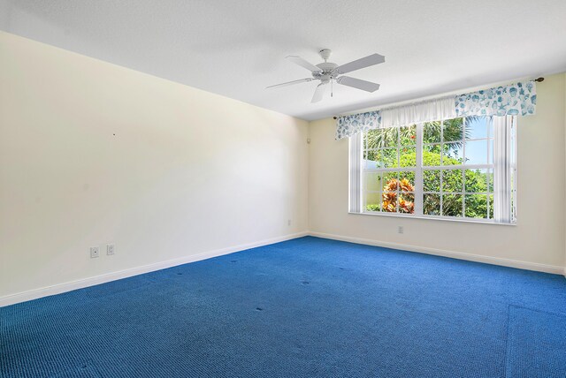 spare room featuring carpet flooring and ceiling fan