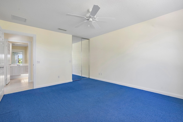 spare room with carpet and ceiling fan