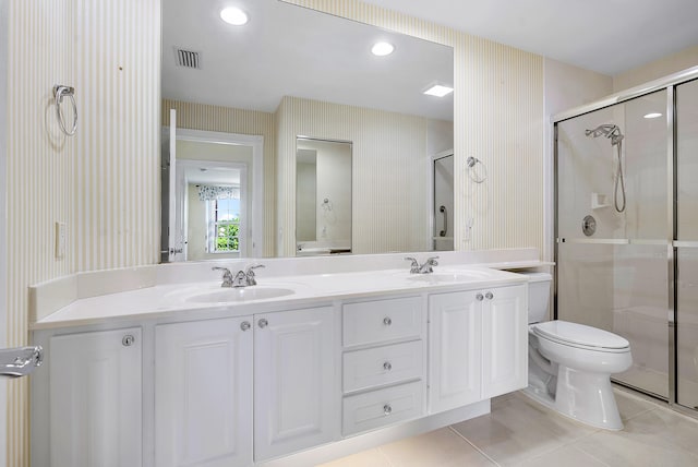 bathroom with toilet, tile patterned flooring, walk in shower, and double vanity