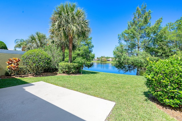 view of yard with a patio and a water view