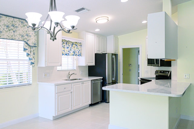 kitchen with light tile patterned floors, kitchen peninsula, stainless steel appliances, decorative backsplash, and decorative light fixtures