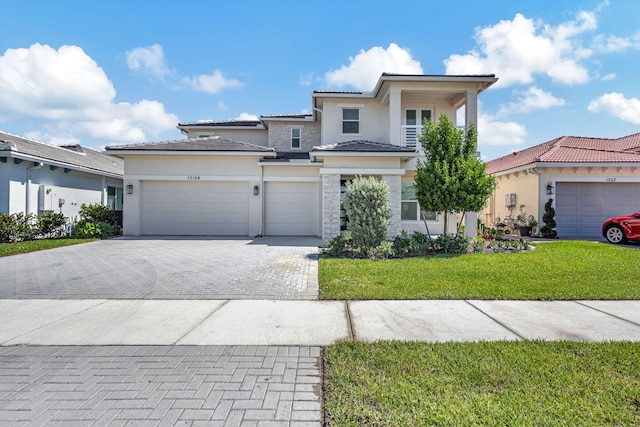 view of front of property with a garage and a front lawn