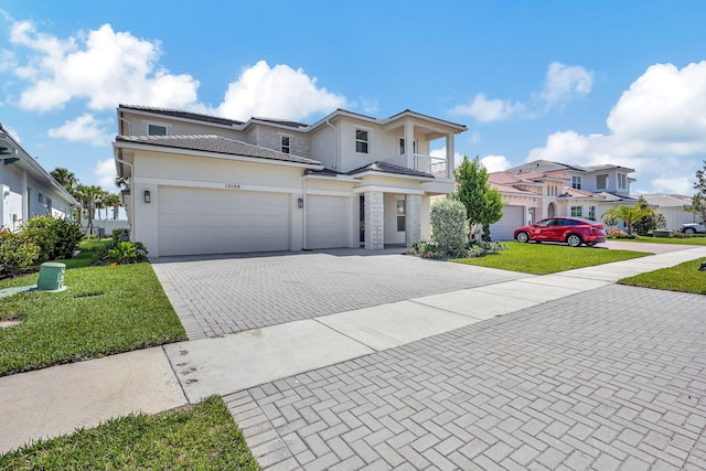 view of front of property featuring a garage and a front lawn