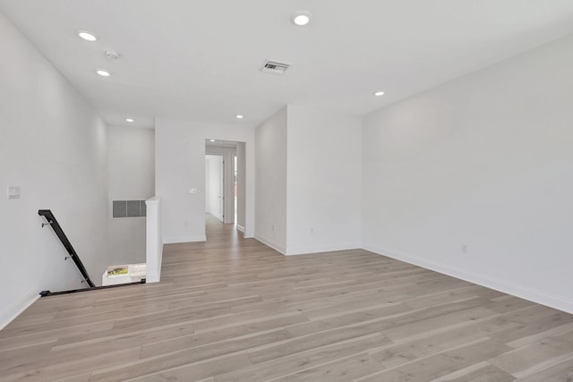 spare room with light wood-type flooring, visible vents, and recessed lighting