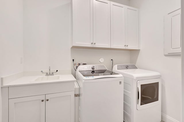 laundry area with separate washer and dryer, a sink, cabinet space, and electric panel