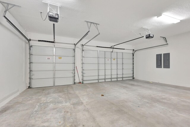 garage with electric panel and a garage door opener