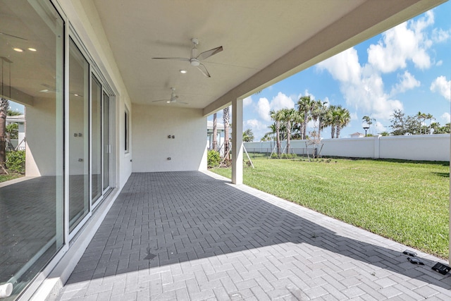 view of patio / terrace with ceiling fan and fence