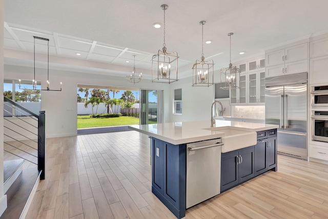 kitchen featuring light countertops, appliances with stainless steel finishes, glass insert cabinets, and white cabinets