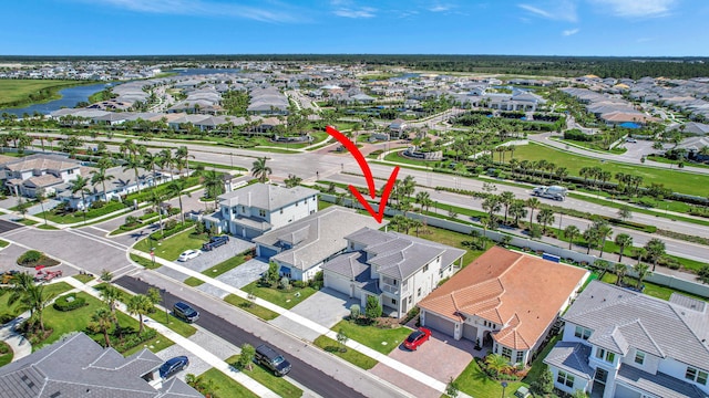 bird's eye view featuring a water view and a residential view