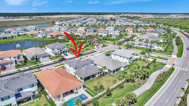 bird's eye view featuring a water view and a residential view