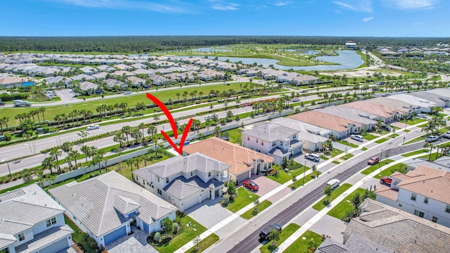 birds eye view of property with a water view and a residential view